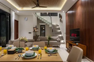 a living room with a table and a couch at Pristine & Modern Gem Luxury 3bd Villa in Umalas in Kerobokan