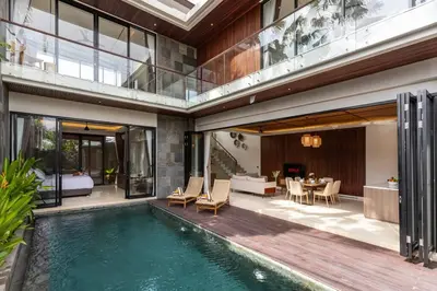 an indoor swimming pool in a house with a bedroom at Pristine & Modern Gem Luxury 3bd Villa in Umalas in Kerobokan