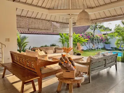 a living room with a couch and a table at Villa Rocher - Modern 3 BR Villa Batu Belig 3 min beach in Seminyak
