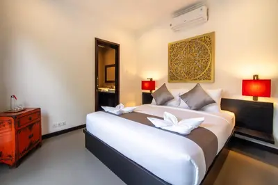 a bedroom with a large white bed with two pillows at Villa Eleni - Your Private Oasis in Seminyak - A Hosted Luxury Boutique Villa in Seminyak