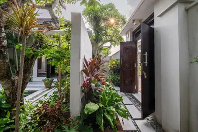 an entrance to a house with plants and a door at Villa Eleni - Your Private Oasis in Seminyak - A Hosted Luxury Boutique Villa in Seminyak