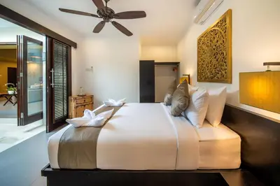 a bedroom with a large bed with a ceiling fan at Villa Eleni - Your Private Oasis in Seminyak - A Hosted Luxury Boutique Villa in Seminyak