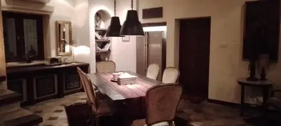a kitchen with a table and chairs and a refrigerator at Villa Gadja Bali in Jimbaran