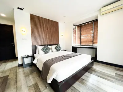 a bedroom with a large bed and a window at Hotel ARA Legian in Legian