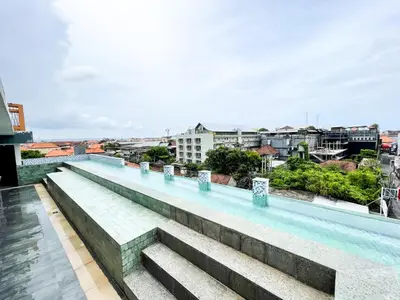 a swimming pool on the roof of a building at Hotel ARA Legian in Legian