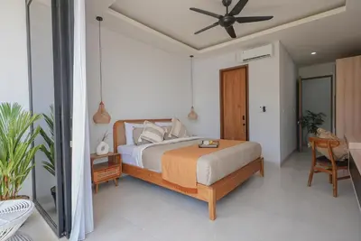 a bedroom with a bed and a ceiling fan at Shanti Villa - 3BR Luxury in Seminyak in Badung