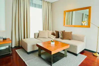 a living room with a couch and a table at Jivala 1 BR Private Pool Villa in Seminyak