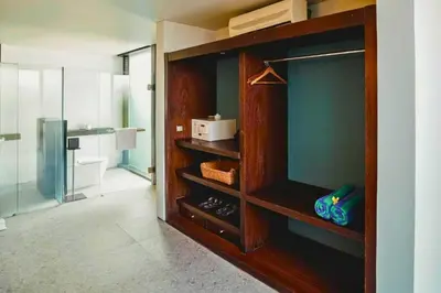 a bathroom with a glass shower and a room with a toilet at Jivala 1 BR Private Pool Villa in Seminyak