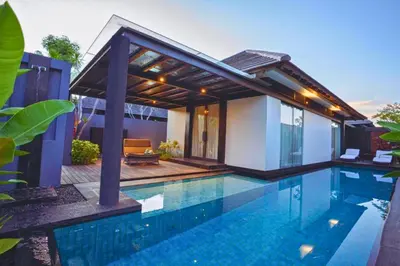 a swimming pool in front of a villa at Jivala 1 BR Private Pool Villa in Seminyak