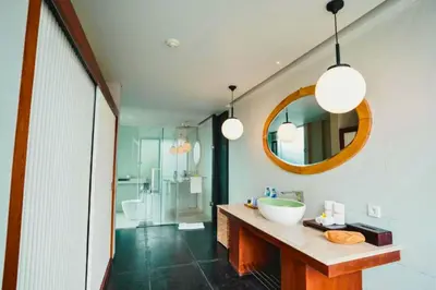 a bathroom with a sink and a mirror at Jivala 1 BR Private Pool Villa in Seminyak