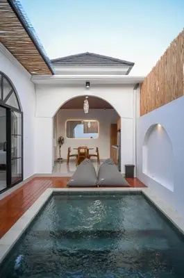 a swimming pool in the middle of a house at Eunoia Villa in Jimbaran
