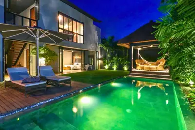 a swimming pool in the backyard of a house at Bintarti 3 BR Private Pool Villa in Canggu