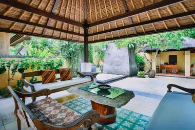 an outdoor living room with a table and chairs at Vanshika 1 BR Garden Villa Shared Pool in Sanur