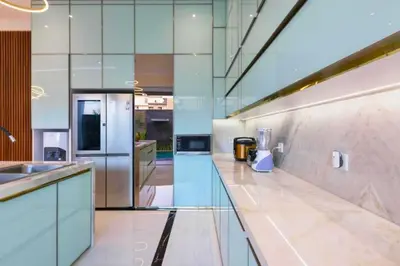 a large kitchen with a counter and a refrigerator at Lashana 3 BR Private Pool Villa in Legian