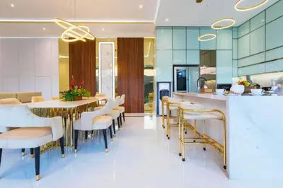 a kitchen with a table and chairs in a kitchen at Lashana 3 BR Private Pool Villa in Legian