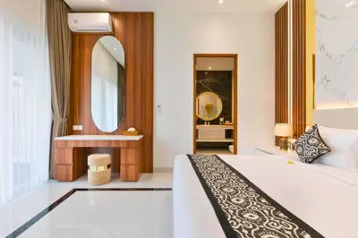 a bedroom with a bed and a large mirror at Nayana 4 BR Private Pool Villa in Legian