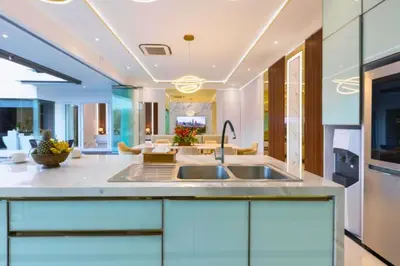 a kitchen with a sink and a living room at Nayana 4 BR Private Pool Villa in Legian