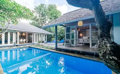 an exterior view of a house with a swimming pool at Villa 9C in Seminyak