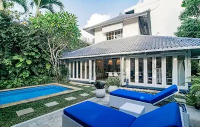 a villa with a swimming pool and a house at Villa 9C in Seminyak