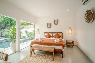 a bedroom with a bed and a pool at Villa Lemone 5 by Bali Villa Solutions in Seminyak