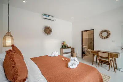 a bedroom with a bed with two stuffed animals on it at Villa Lemone 5 by Bali Villa Solutions in Seminyak