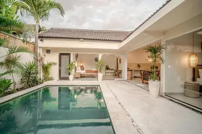 a swimming pool in a house with palm trees at Villa Lemone 5 by Bali Villa Solutions in Seminyak