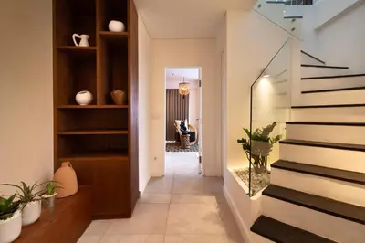a hallway of a house with stairs and plants at The Cruise Berawa - Design Apartments & Penthouses by CPM Bali in Canggu