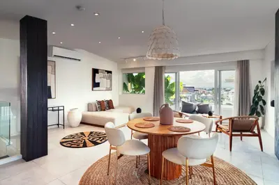 a living room with a table and chairs at The Cruise Berawa - Design Apartments & Penthouses by CPM Bali in Canggu