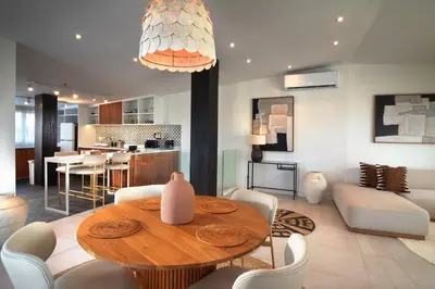 a dining room and living room with a table and chairs at The Cruise Berawa - Design Apartments & Penthouses by CPM Bali in Canggu