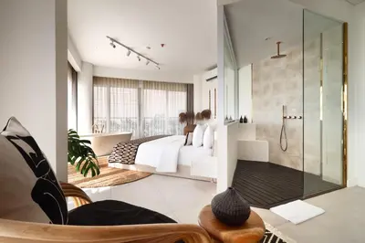 a bathroom with a large bed and a bath tub at The Cruise Berawa - Design Apartments & Penthouses by CPM Bali in Canggu