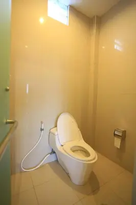 a bathroom with a toilet with a water hose at Nyoman Villa Sanur in Sanur