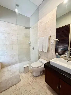 a bathroom with a toilet and a sink at MJ Orchid Residence in Seminyak