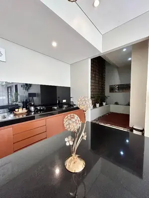 a kitchen with a plant in the middle of it at MJ Orchid Residence in Seminyak
