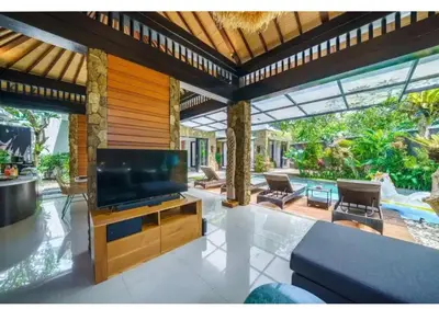 a living room with a large flat screen tv at Villa J in Nusa Dua