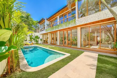 an exterior view of a house with a swimming pool at Villa Aztec - 6BDR private pool and garden in Seminyak