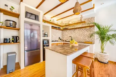 a kitchen with a island and a counter top at Villa Aztec - 6BDR private pool and garden in Seminyak