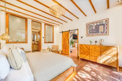 a bedroom with a bed and a dresser at Villa Aztec - 6BDR private pool and garden in Seminyak