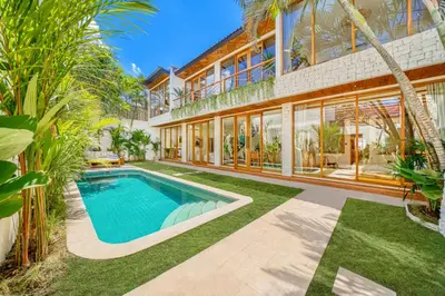 an exterior view of a house with a swimming pool at Villa Aztec - 6BDR private pool and garden in Seminyak