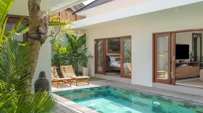 a villa with a swimming pool and a house at Villa Lange 2 by Villa Finder in Seminyak