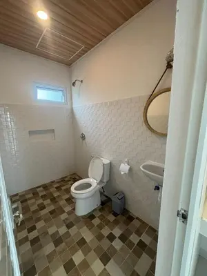 a bathroom with a toilet and a sink at Jabu Hasian Bali in Kerobokan