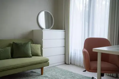 a living room with a green couch and a chair at Paradise Haven in Nusa Dua in Nusa Dua