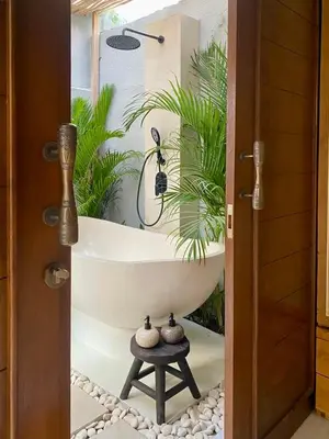 a bathroom with a bathtub with a plant at Paradise Haven in Nusa Dua in Nusa Dua
