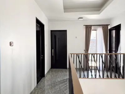 a hallway with a staircase and a black door at Bellagio Villas in Seminyak