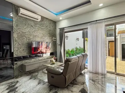 a living room with a couch and a tv at Bellagio Villas in Seminyak