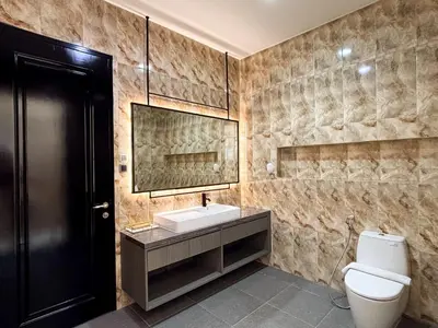 a bathroom with a sink and a toilet and a mirror at Bellagio Villas in Seminyak