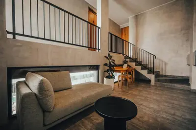 a living room with a couch and a staircase at Villa Cintamu - Modern Spacious Villa in Prime Berawa Location in Canggu