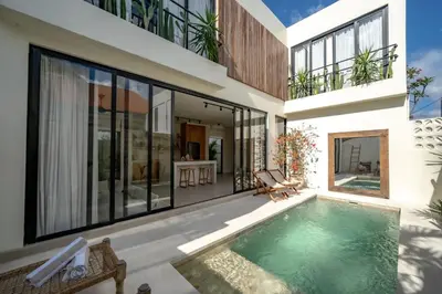 an external view of a house with a swimming pool at Casanna Umalas in Canggu