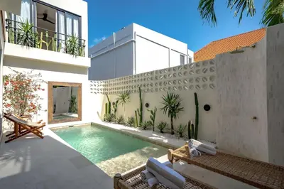 a swimming pool in the backyard of a house at Casanna Umalas in Canggu