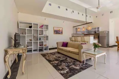 a living room with a couch and a table at Spacious 2bdr Seminyak walking eat&shop street in Seminyak