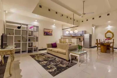 a living room with a couch and a table at Spacious 2bdr Seminyak walking eat&shop street in Seminyak